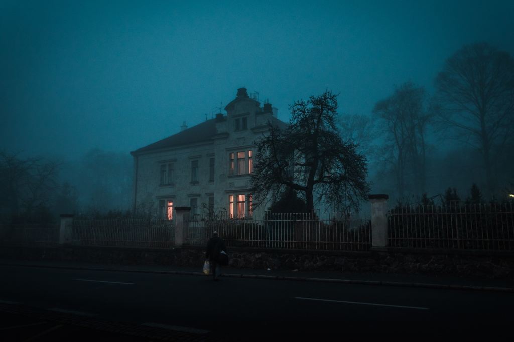 A manor house in a foggy evening.